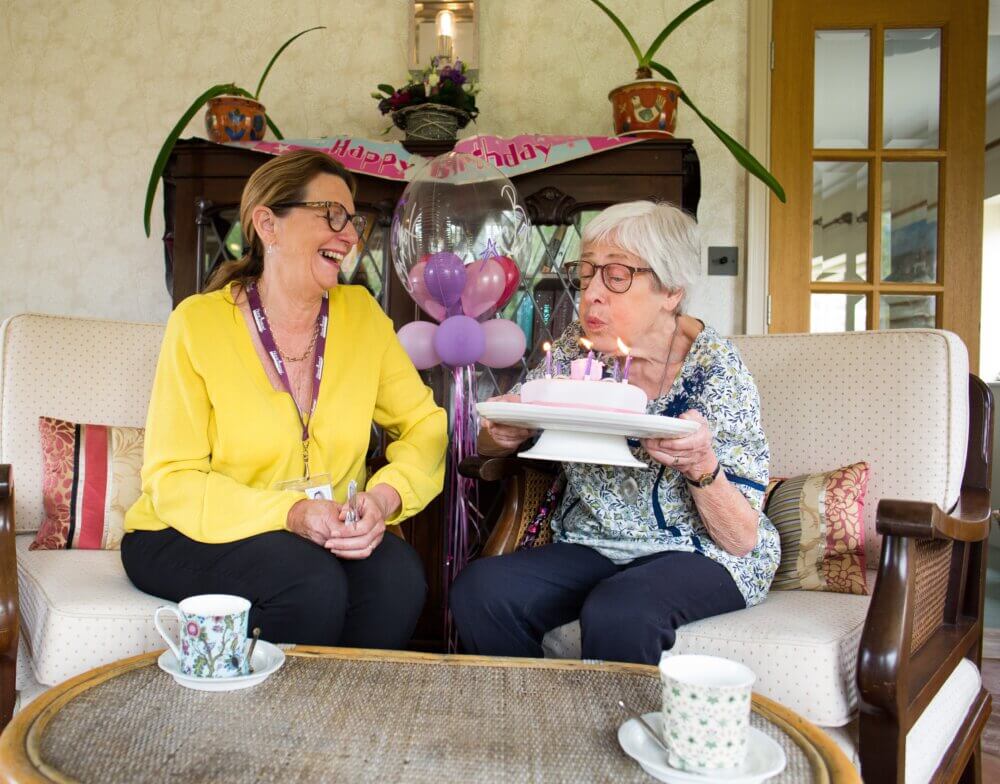 Carer and client with birthday cake