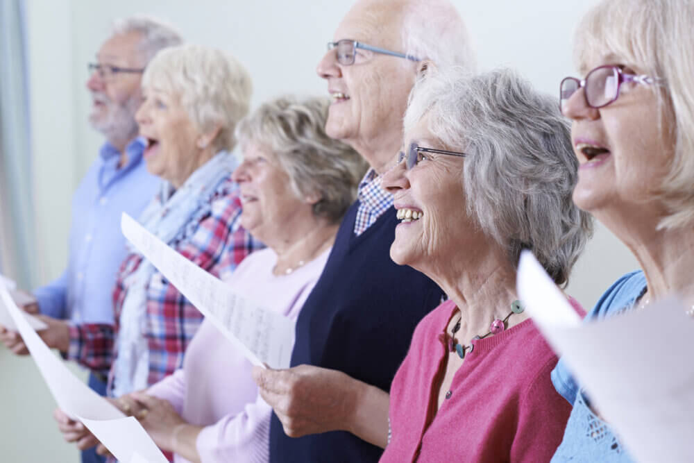 Group of seniors singing and smiling