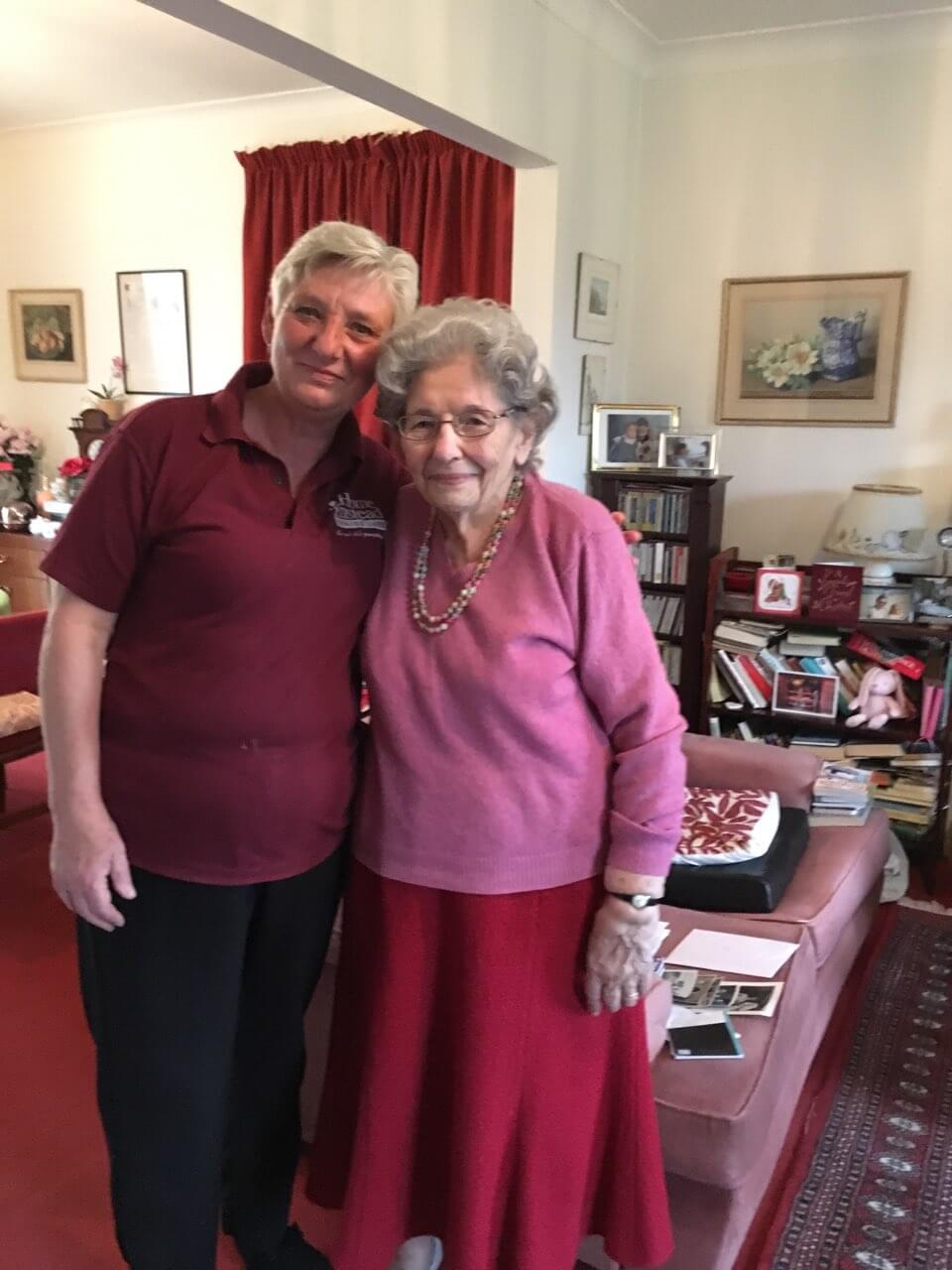 Home Instead care assistant Nicky hugging older person in her own home