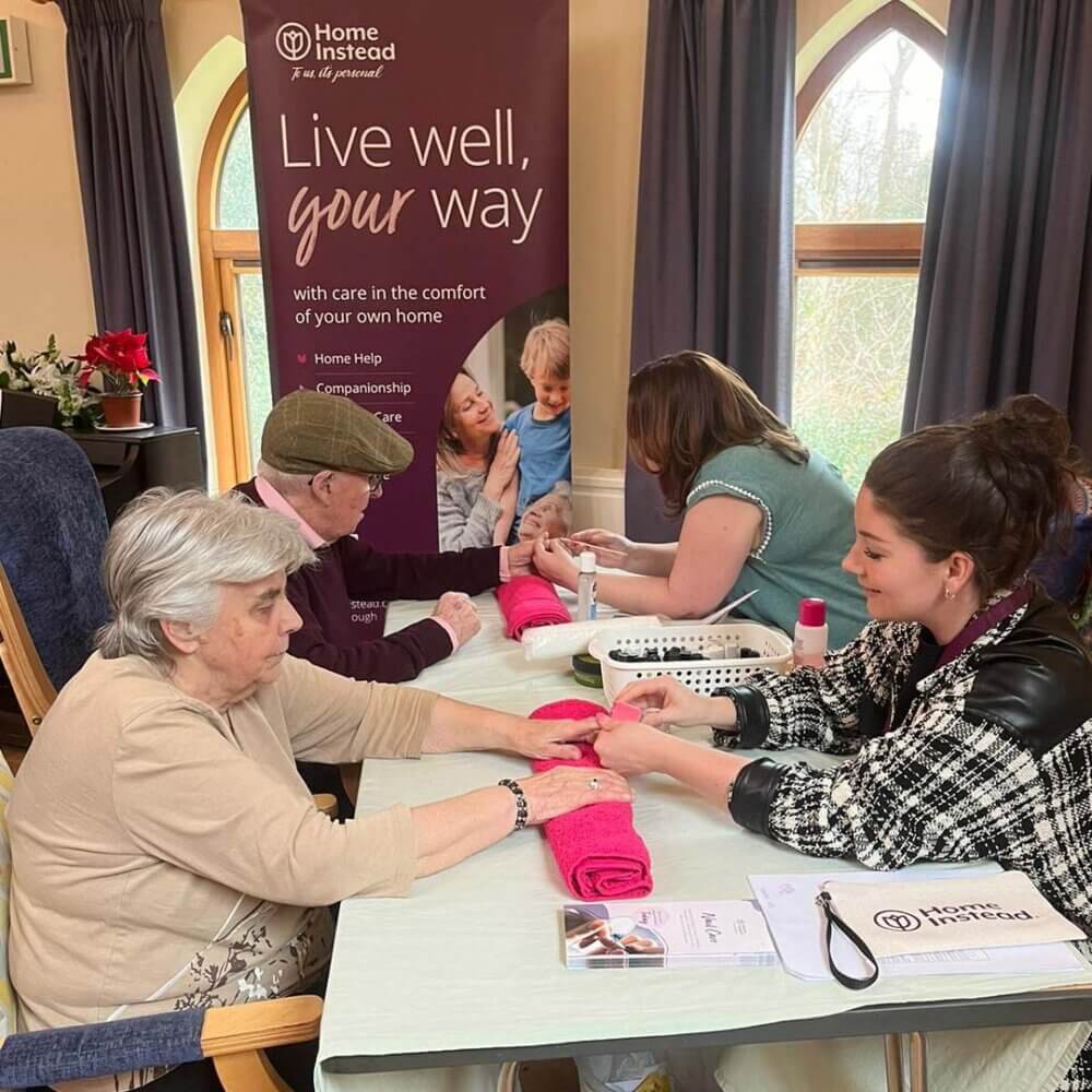 seniors enjoying a manicure from the Home Instead nail care team